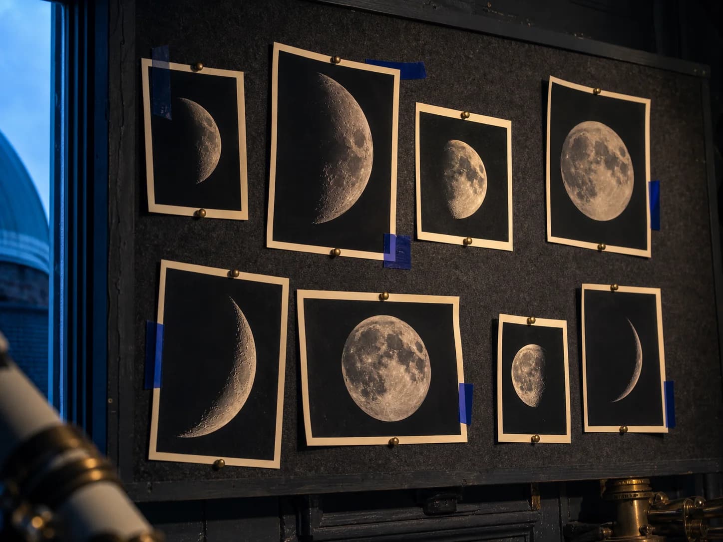 Successive Moon phases photographed above a dark horizon